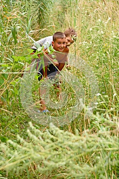 Playing boys in long grass