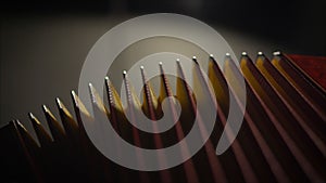 Close-up musician playing the accordion against a black background. playing the button accordion in the studio