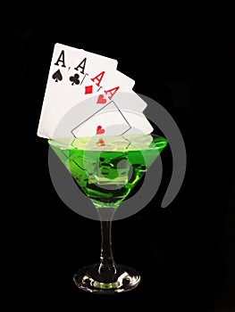 Playing card in a cocktail glass on black background. casino series