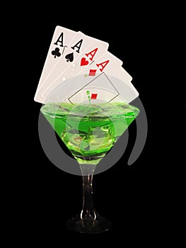 Playing card in a cocktail glass on black background. casino series