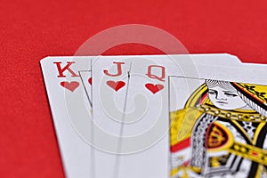 Playing card Heart Jack Queen King on Textured Red Background