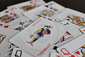 Playing card joker on the background of scattered cards