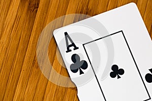 Playing cards ace card close up, isolated on wooden table. Casino concept, risk, chance, good luck or gambling
