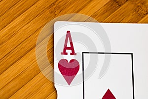 Playing cards ace card close up, isolated on wooden table. Casino concept, risk, chance, good luck or gambling