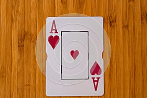 Playing cards ace card close up, isolated on wooden table. Casino concept, risk, chance, good luck or gambling