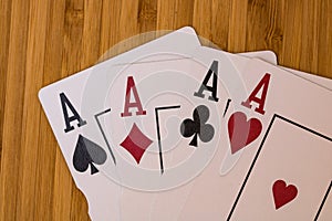 Playing cards aces card close up, isolated on wooden table. Casino concept, risk, chance, good luck or gambling