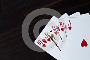 Playing cards on black background. Royal flush