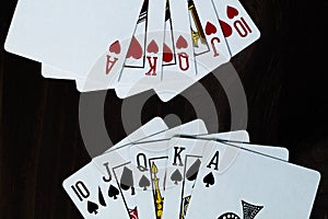 Playing cards on black background. Royal flush