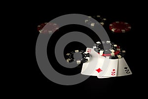 Playing cards on a black table with a winning combination one pair in game poker and chips in the background