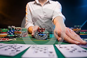Playing cards in a casino. A lot of chips, money. A player in a casino makes bets. Poker