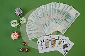 Playing cards in a combination of Flash Royal and poker chips on a green background. Texas Hold`em Poker. Gambling, business