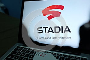 Playing cards and computer screen with the Google Stadia