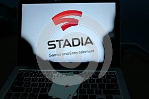 Playing cards and computer screen with the Google Stadia