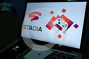 Playing cards and computer screen with the Google Stadia
