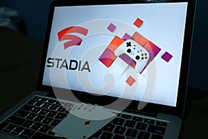 Playing cards and computer screen with the Google Stadia