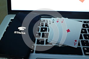 Playing cards and computer screen with the Google Stadia