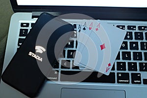 Playing cards and computer screen with the Google Stadia