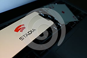 Playing cards and computer screen with the Google Stadia