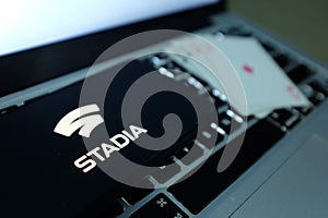 Playing cards and computer screen with the Google Stadia