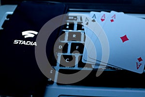 Playing cards and computer screen with the Google Stadia