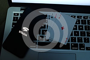 Playing cards and computer screen with the Google Stadia