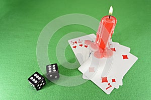 Playing cards, dice and a candle