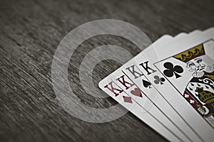 Playing cards four kings. wooden background.