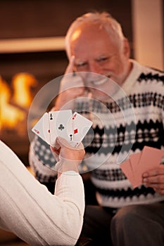 Playing cards in front of fireplace