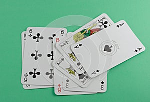 Playing cards on green surface