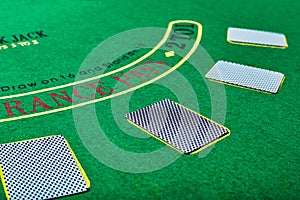 Playing cards on green table surface. Casino, gambling, poker concept