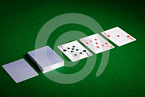 Playing cards on green table surface