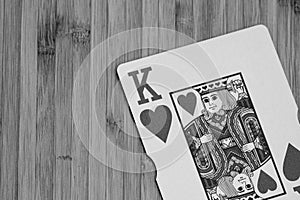 Playing cards king card close up, isolated on wooden table. Casino concept, risk, chance, good luck or gambling