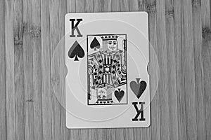 Playing cards king card close up, isolated on wooden table. Casino concept, risk, chance, good luck or gambling