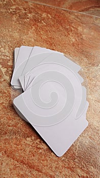 Playing cards modern mock up. Deck of playing card on a brown and beige marble surface.Blank white cards or business