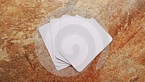 Playing cards modern mock up. Deck of playing card on a brown and beige marble surface.Blank white cards or business