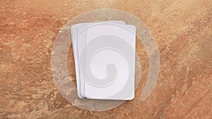 Playing cards modern mock up. Deck of playing card on a brown and beige marble surface.Blank white cards or business