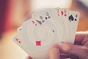 Playing cards: Poker cards in the hand of a young man