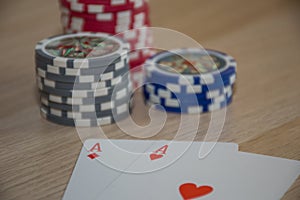 Playing cards and poker chips on grey background