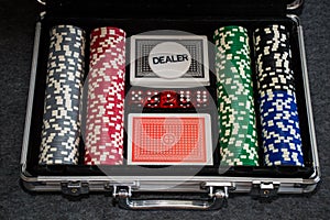 Playing cards and poker chips on grey background