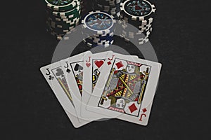 Playing cards and poker chips on grey background
