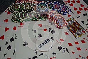 Playing cards and poker chips on grey background