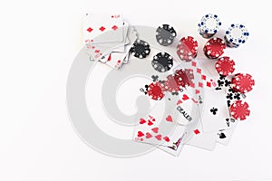 Playing cards and poker chips on white background