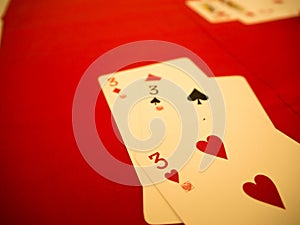 Playing cards on red table
