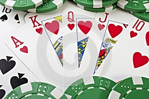 Playing cards (royal flush) and casino chips