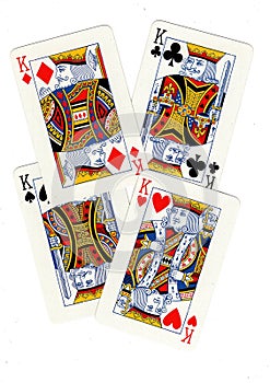 Playing cards showing four kings.