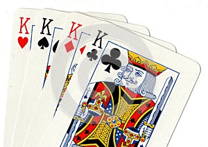 Playing cards showing a hand of four kings.