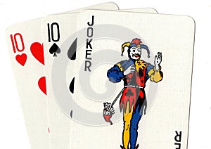 Playing cards showing a joker and a pair of tens.