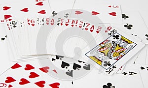 Playing cards spreaded on the white background.