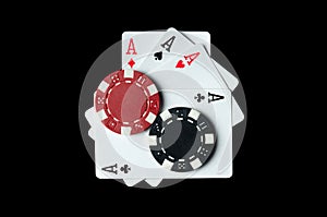 Playing cards with a winning combination of four of a kind or quads and chips on a black table in a club