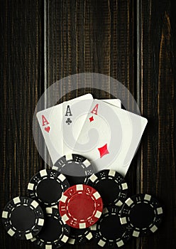 Playing cards with a winning combination of three of a kind or set on a black vintage table in a poker club. Winning in sports